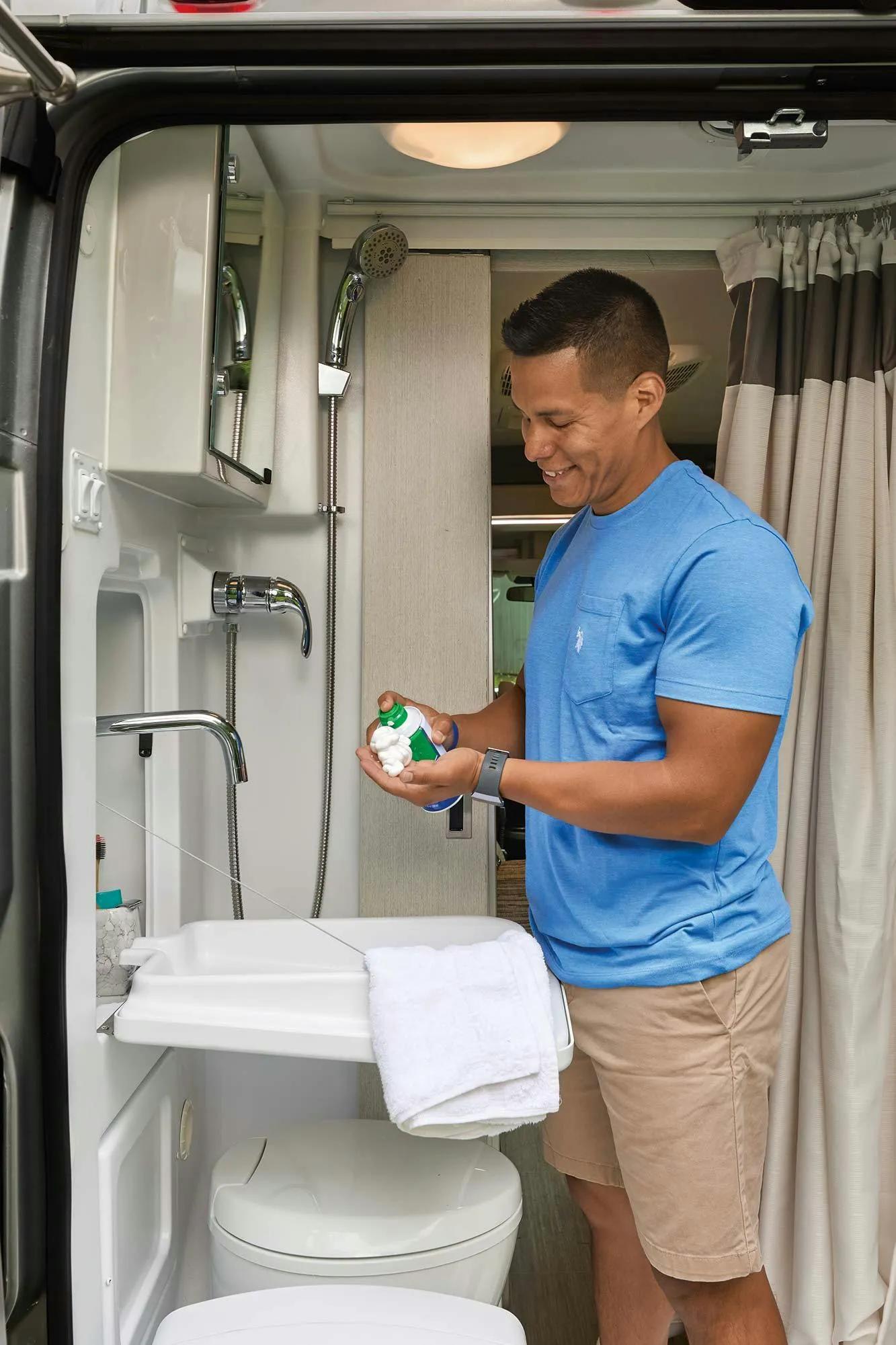 2022 Thor Rize Class B RV 18M Camper Van Lifestyle Wet Bath with man standing and shaving bathroom key feature