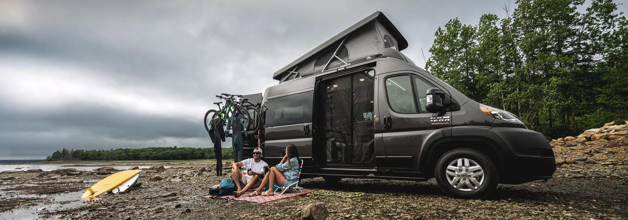 2022 Thor Scope Class B RV Camper Van Lifestyle Maine Corporate photo shoot at campsite couple seated slider size